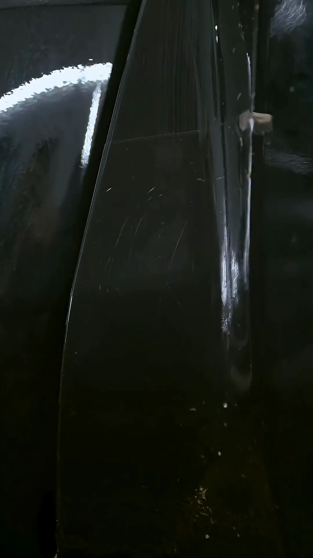 Close-up of film along the edge of a glossy door panel