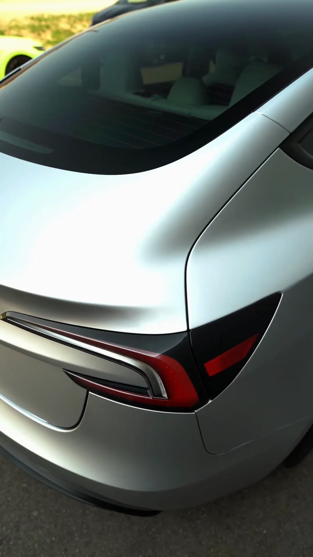 Rear of a silver Tesla in the shop bay