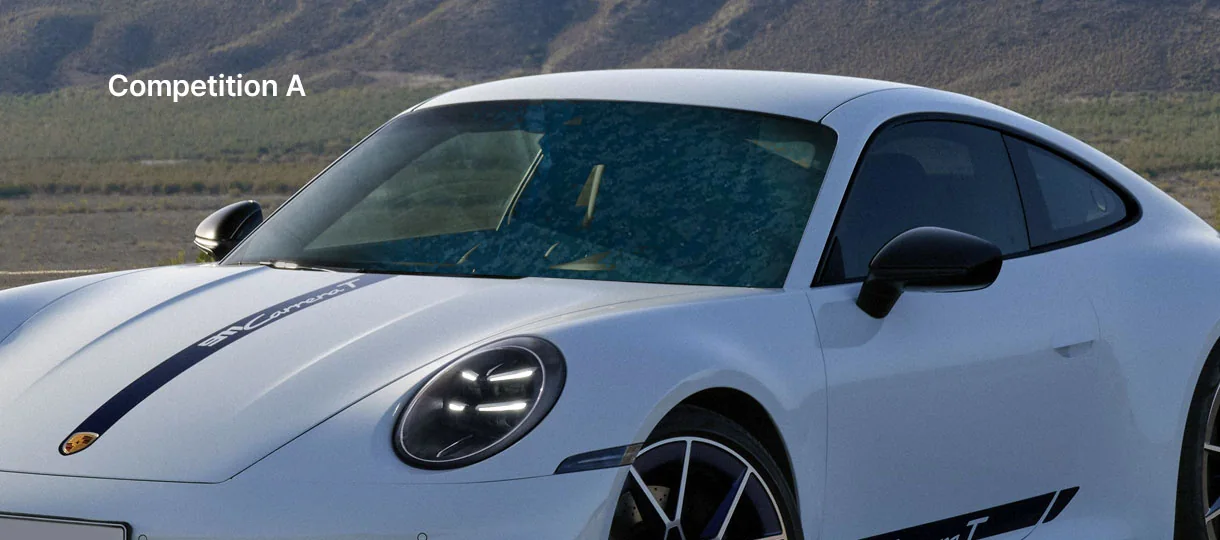 A white Porsche 911 whose windshield film has delaminated into a cloudy, blotchy patch